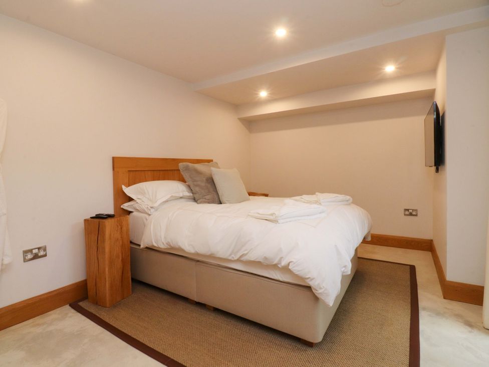 A bedroom with a bed and television at Welly Bob Cottage in Airton
