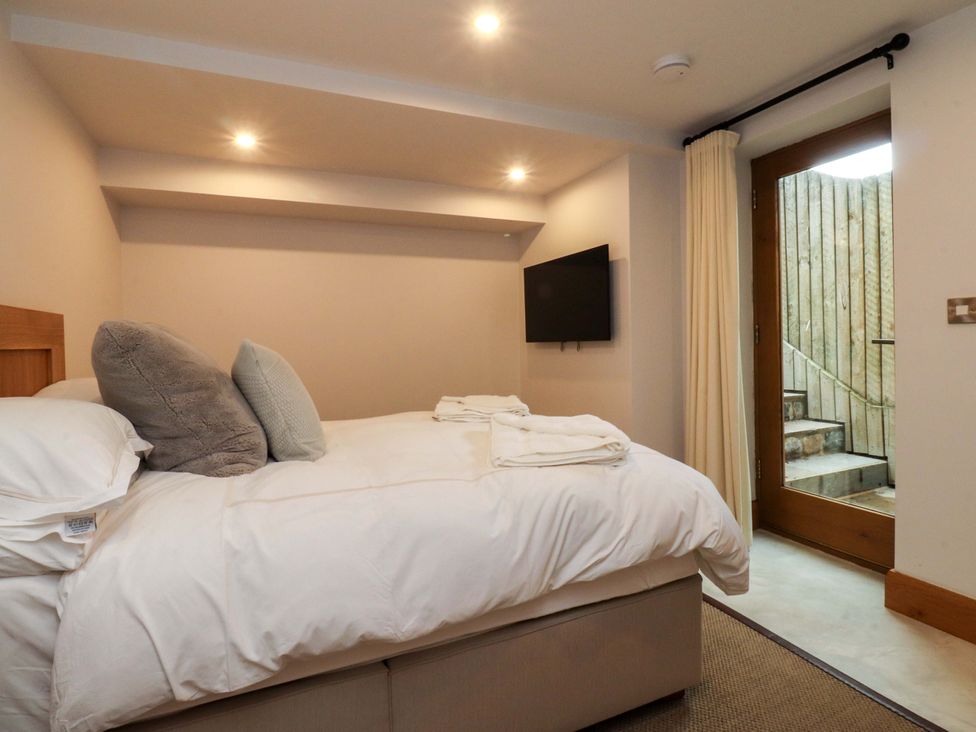 A bedroom with a bed and a TV at Welly Bob Cottage in Airton