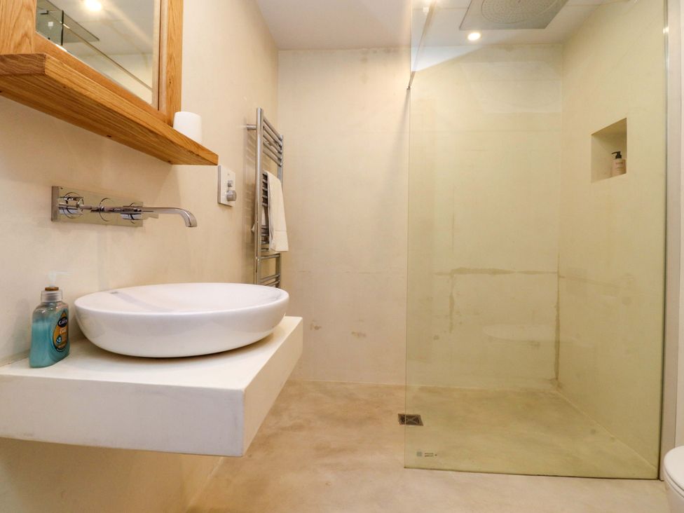 A bathroom with a sink and shower at Welly Bob Cottage in Airton