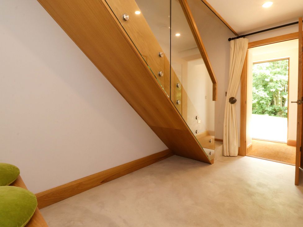 An entryway with a staircase and a door leading outside at Welly Bob Cottage Airton