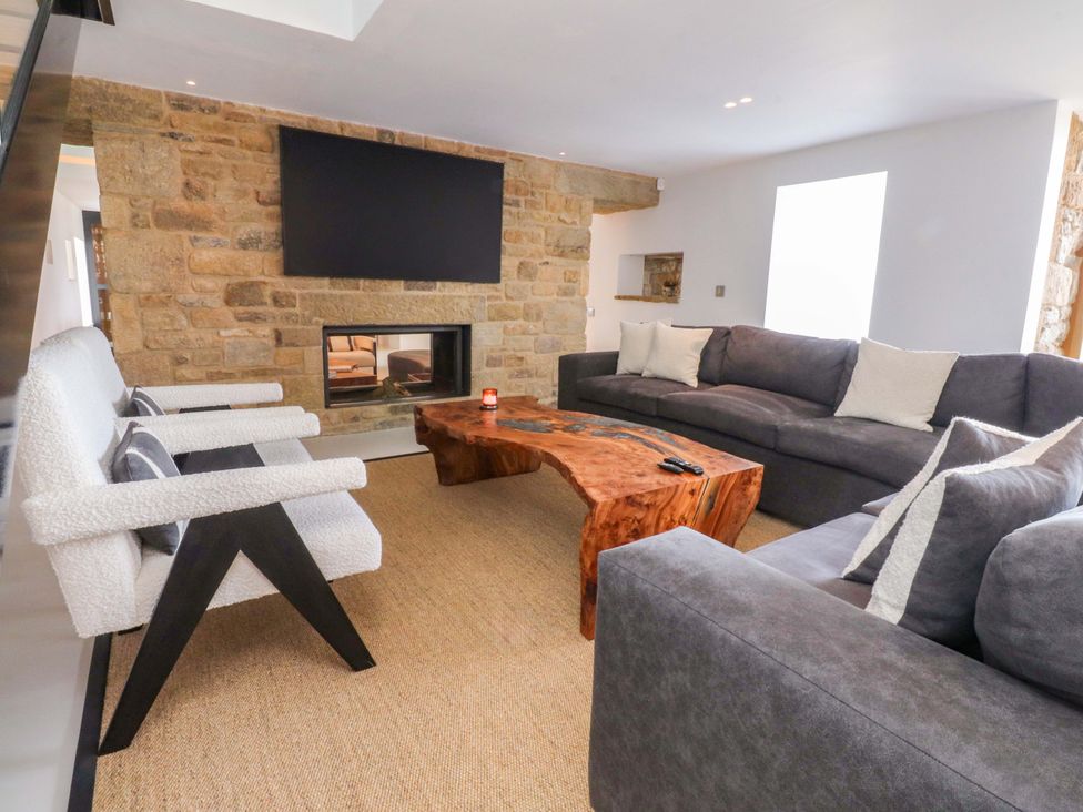 A living room with a sofa and coffee table at Carden Laithe Barn in Threshfield