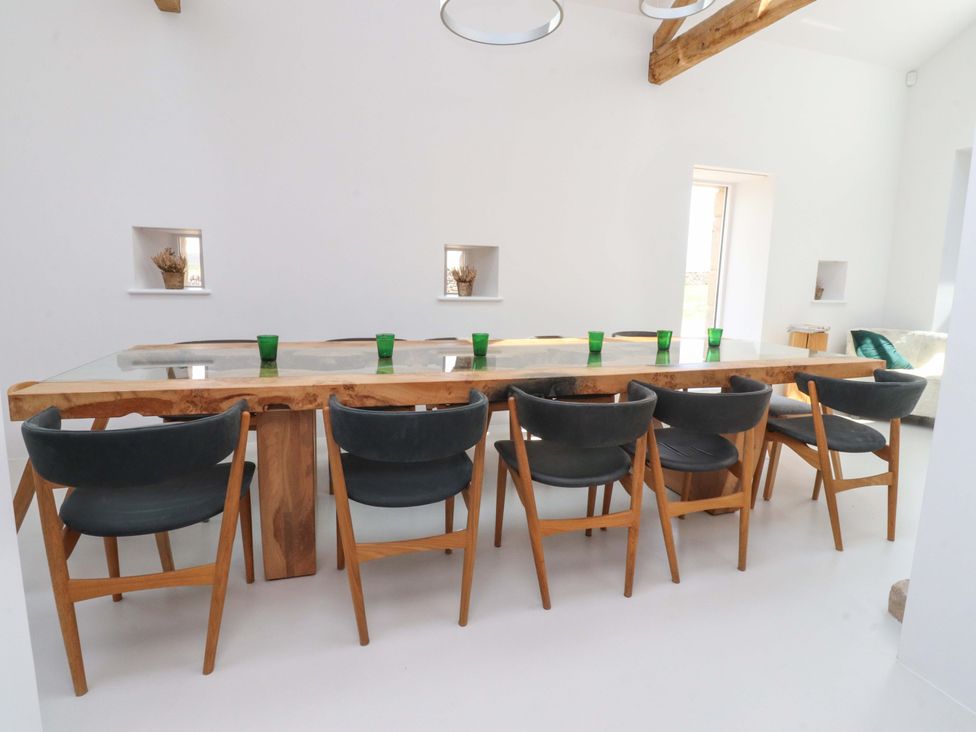 A dining room with a wooden table and chairs at Carden Laithe Barn Threshfield