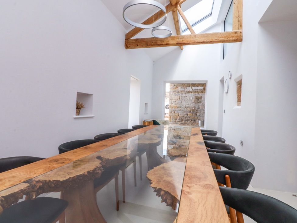 A dining room with a large table and chairs at Carden Laithe Barn in Threshfield