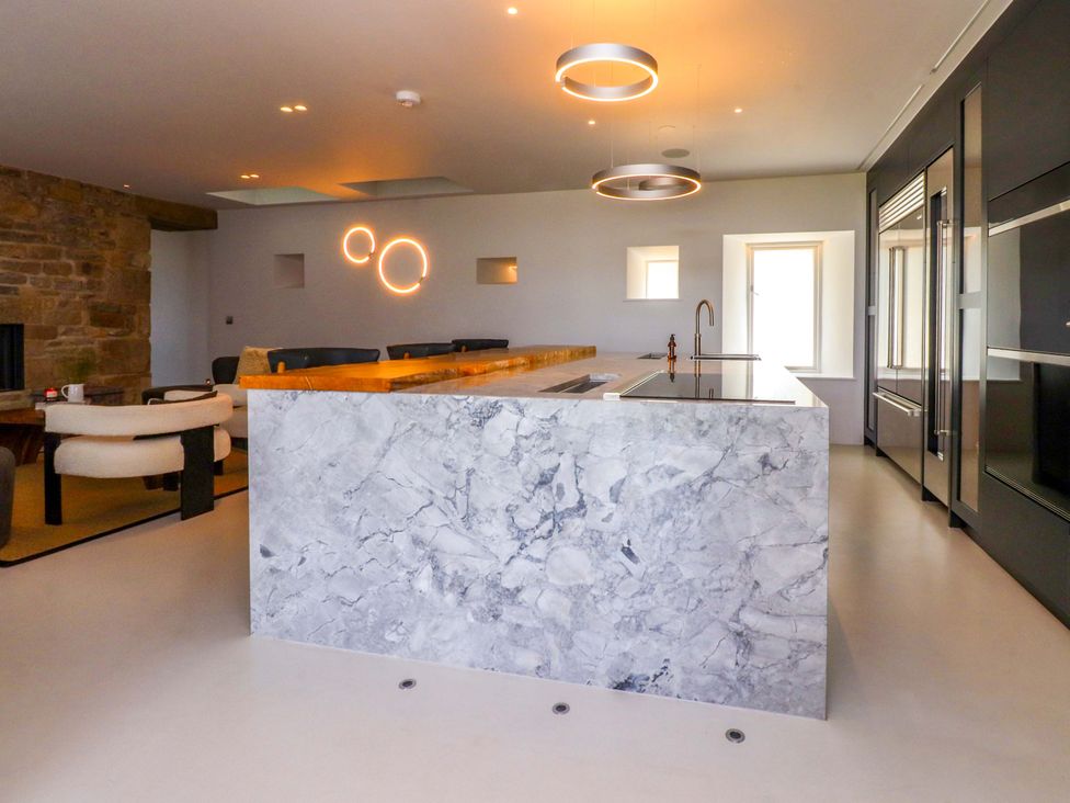 A kitchen with a marble island and modern appliances at Carden Laithe Barn Threshfield