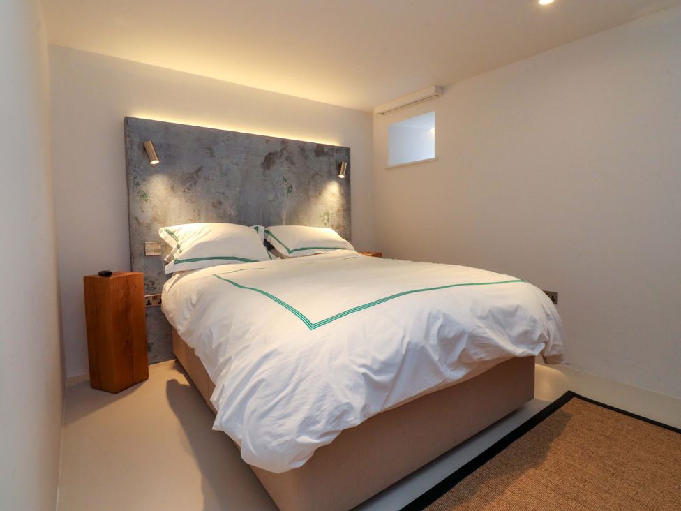 A bedroom with a bed and bedside table at Carden Laithe Barn in Threshfield