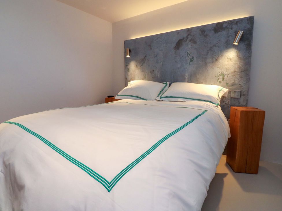 A bedroom with a bed and nightstands at Carden Laithe Barn in Threshfield