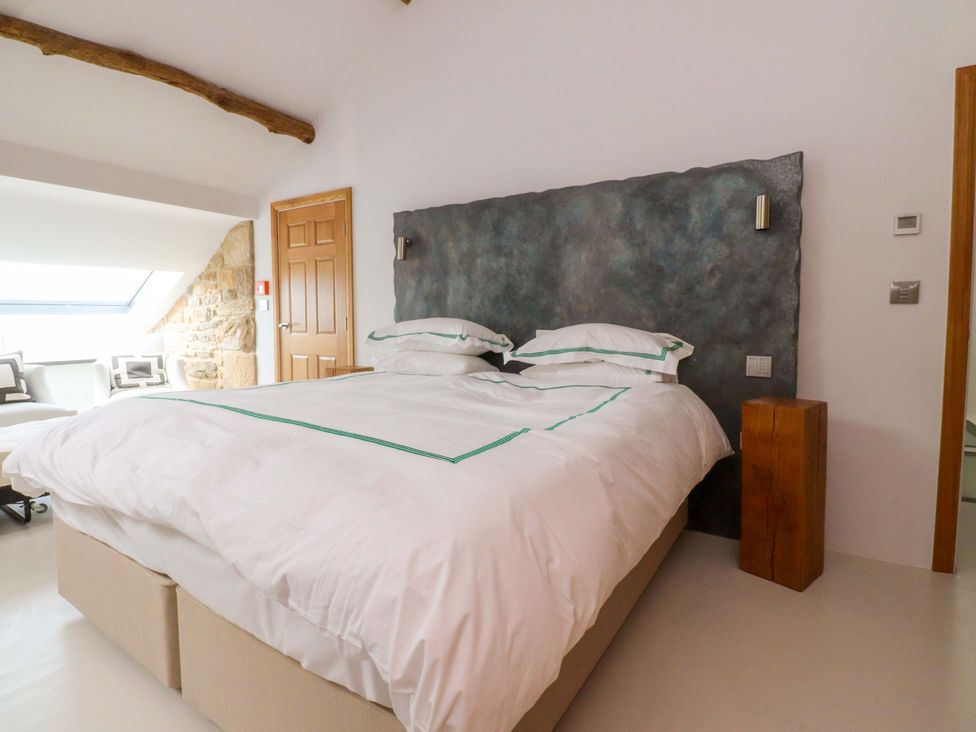 A bedroom with a bed and a bedside table at Carden Laithe Barn Threshfield