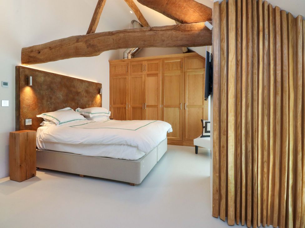 A bedroom with a bed and wardrobe at Carden Laithe Barn Threshfield