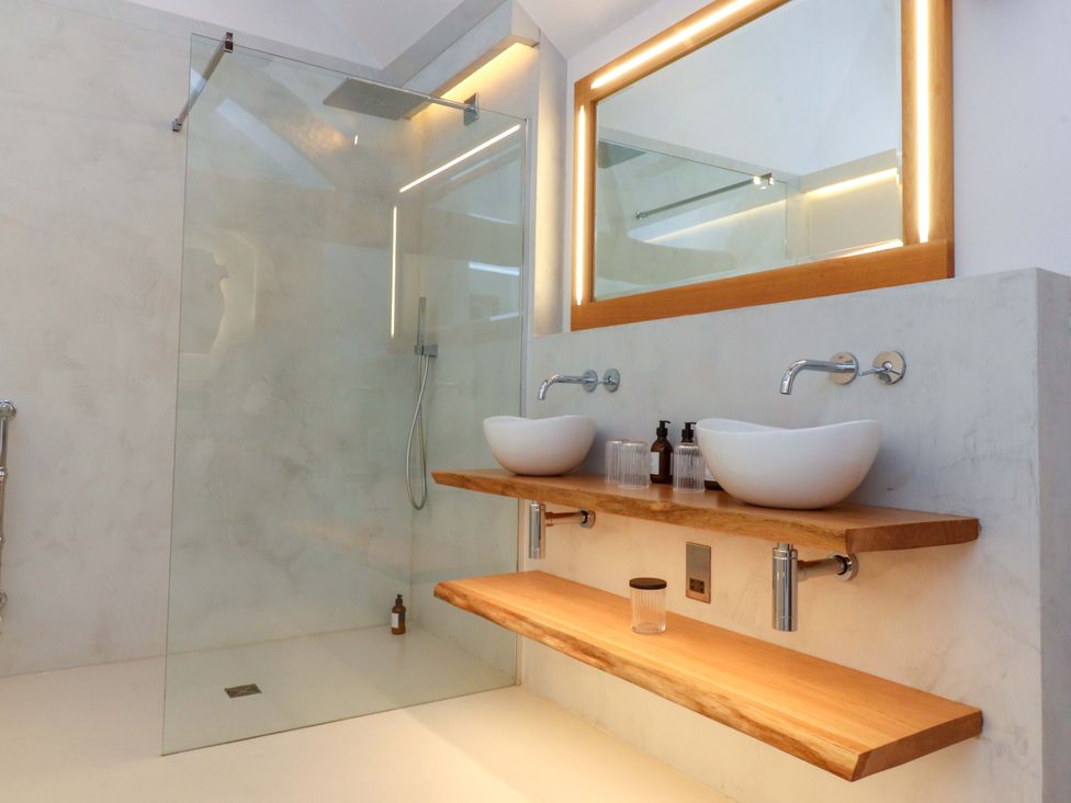 A bathroom with a shower and double sinks at Carden Laithe Barn in Threshfield