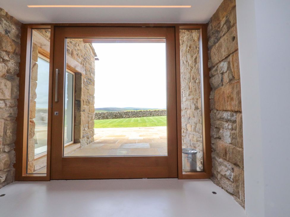 An entrance with stone walls and a view of the garden at Carden Laithe Barn Threshfield