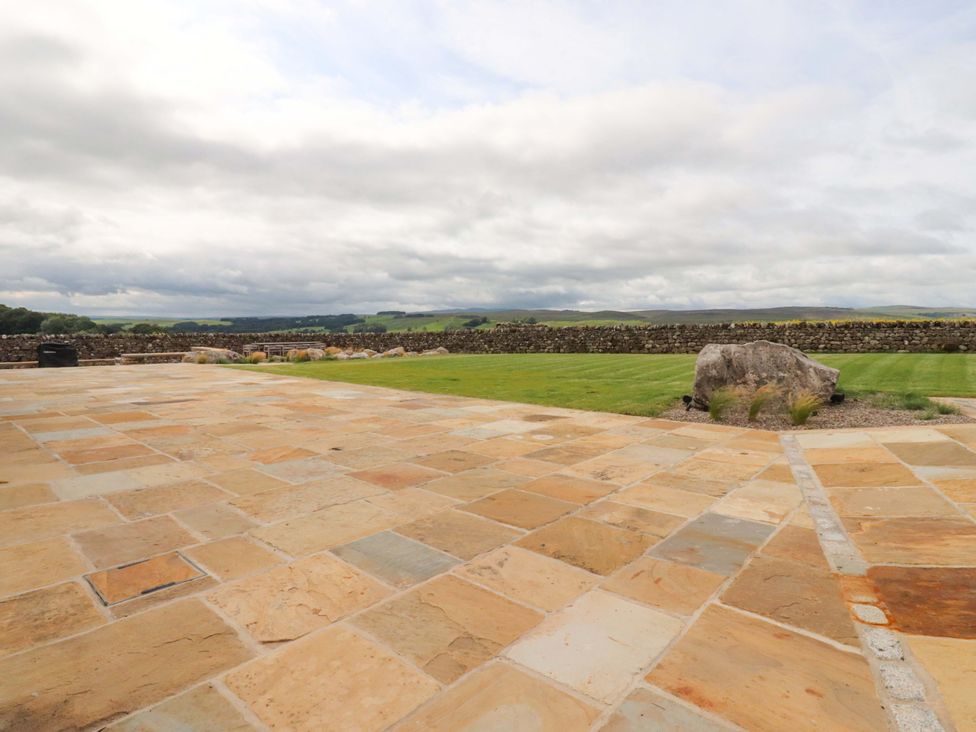 An outdoor area with stone patio and grass at Carden Laithe Barn Threshfield