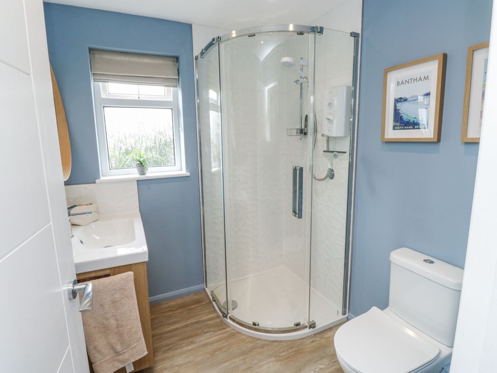 A bathroom with a shower and sink at 1 Island View Thurlestone