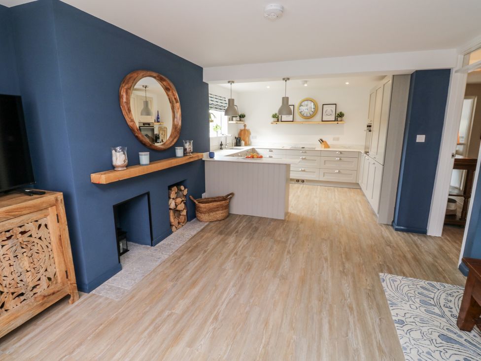 A kitchen with cabinets and a kitchen island at 1 Island View Thurlestone