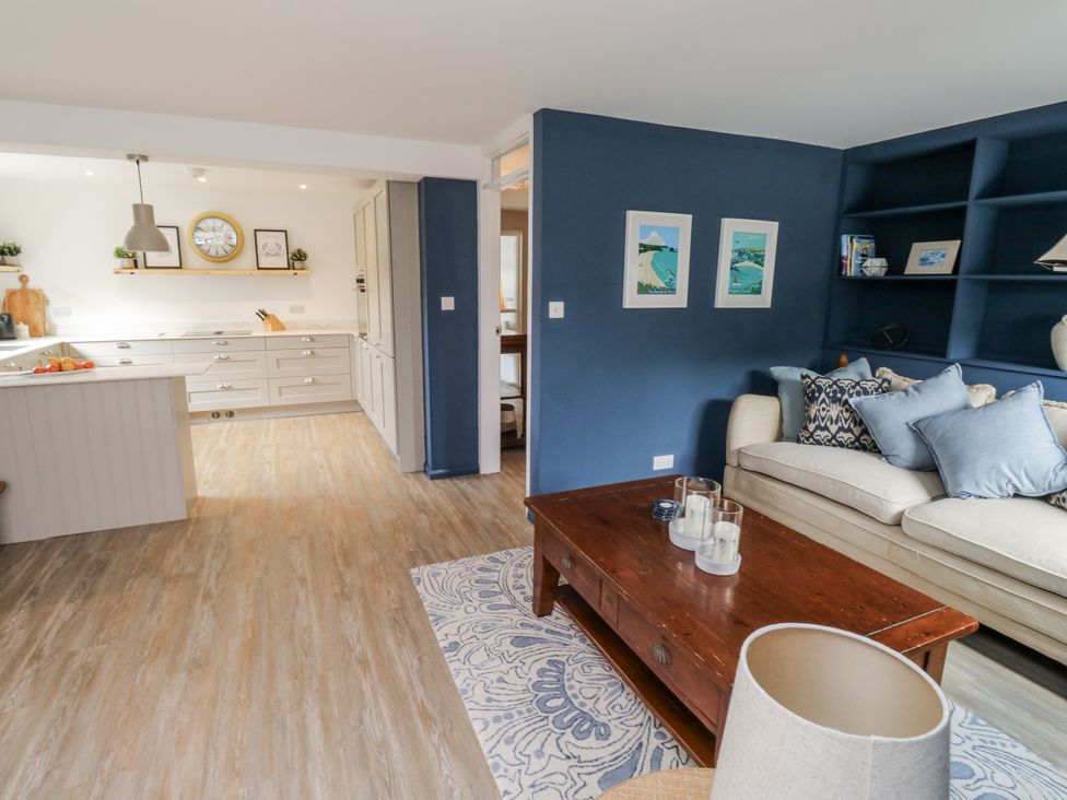 A living room with a coffee table and sofa at 1 Island View in Thurlestone