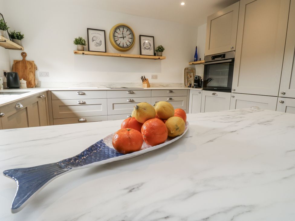A kitchen with a fruit bowl on a marble countertop at 1 Island View Thurlestone