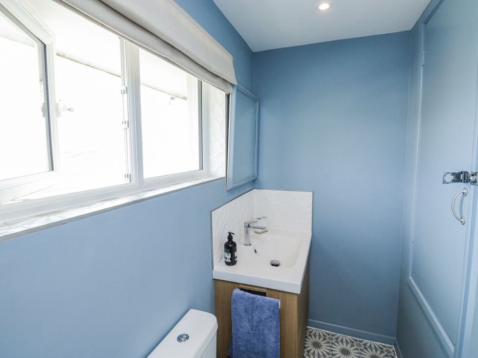 A bathroom with a sink and toilet at 1 Island View in Thurlestone