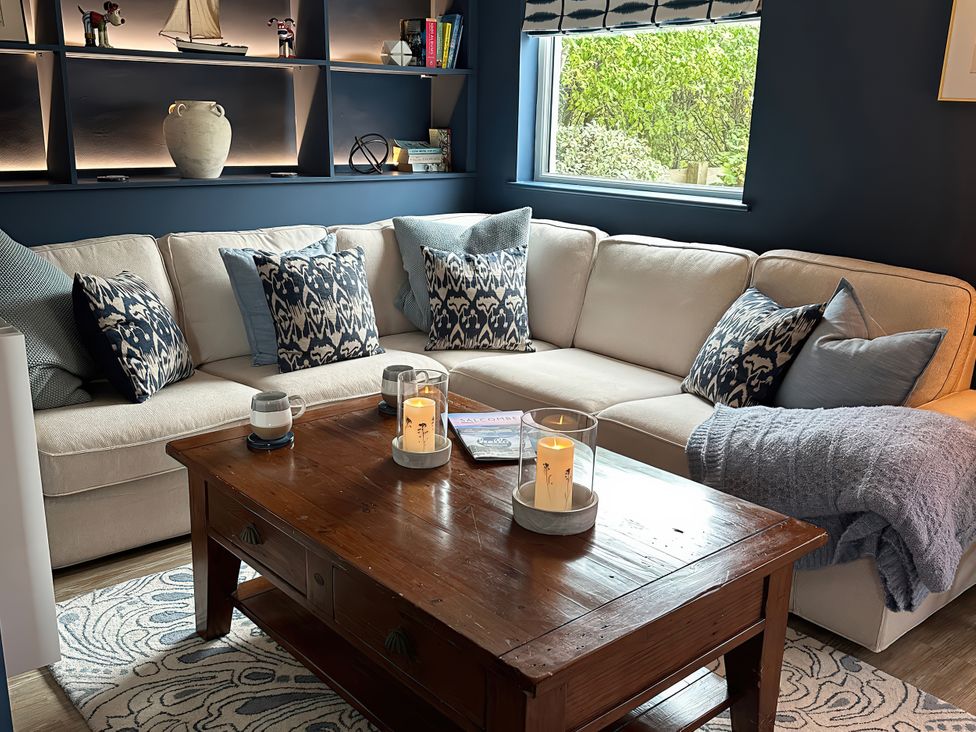 A living room with a sofa and coffee table at Thurlestone, 1 Island View, Thurlestone