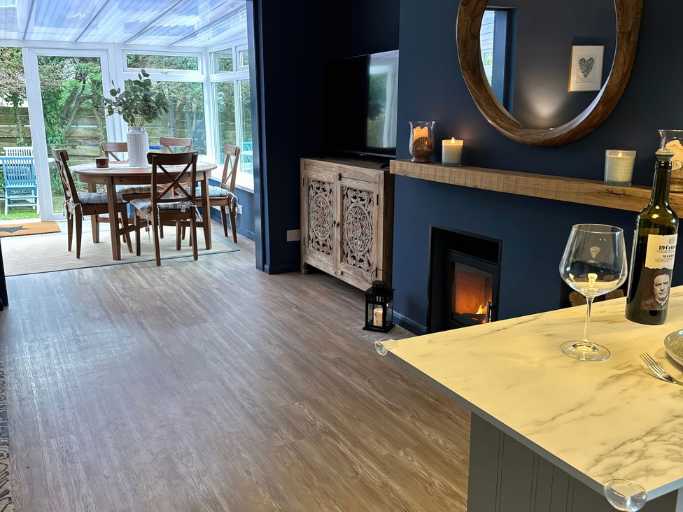 A conservatory with a dining table and chairs at Thurlestone, 1 Island View in Thurlestone