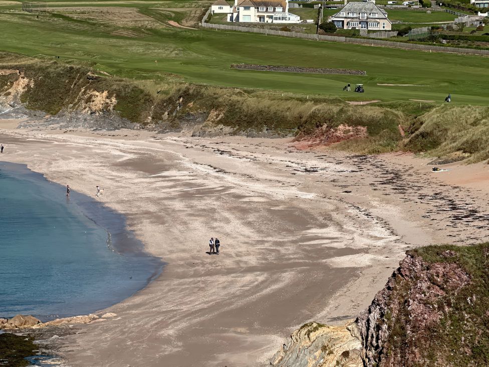 A beach with people walking and a golf course in the background at Thurlestone, 1 Island View Thurlestone