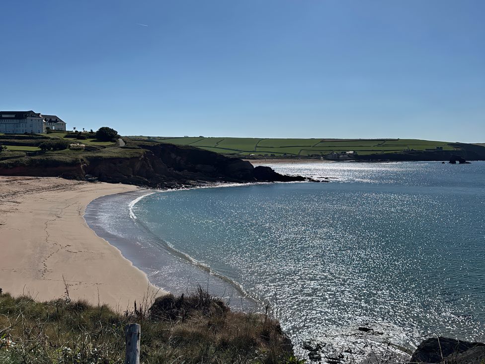 A beach and water view with cliffs and buildings at Thurlestone, Thurlestone