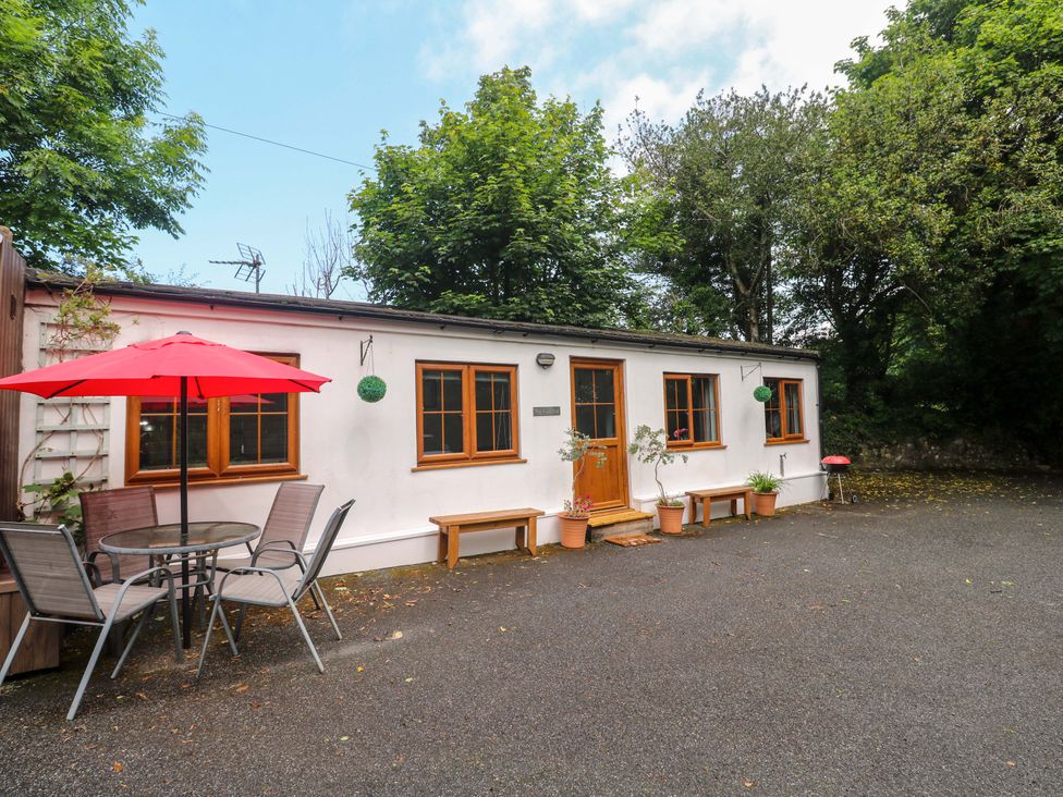 An outdoor seating area with a table and chairs at The Cow Shed