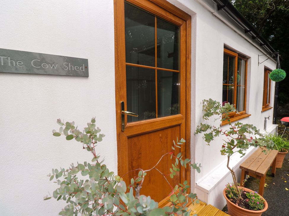 An entrance with a door and windows at The Cow Shed