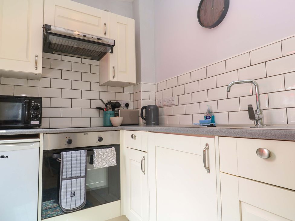 A kitchen with appliances and a sink at The Cow Shed