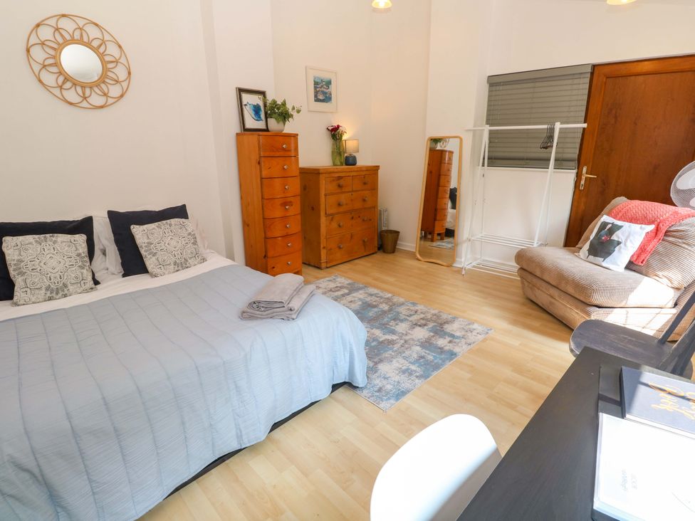 A bedroom with a bed and dresser at The Cow Shed 