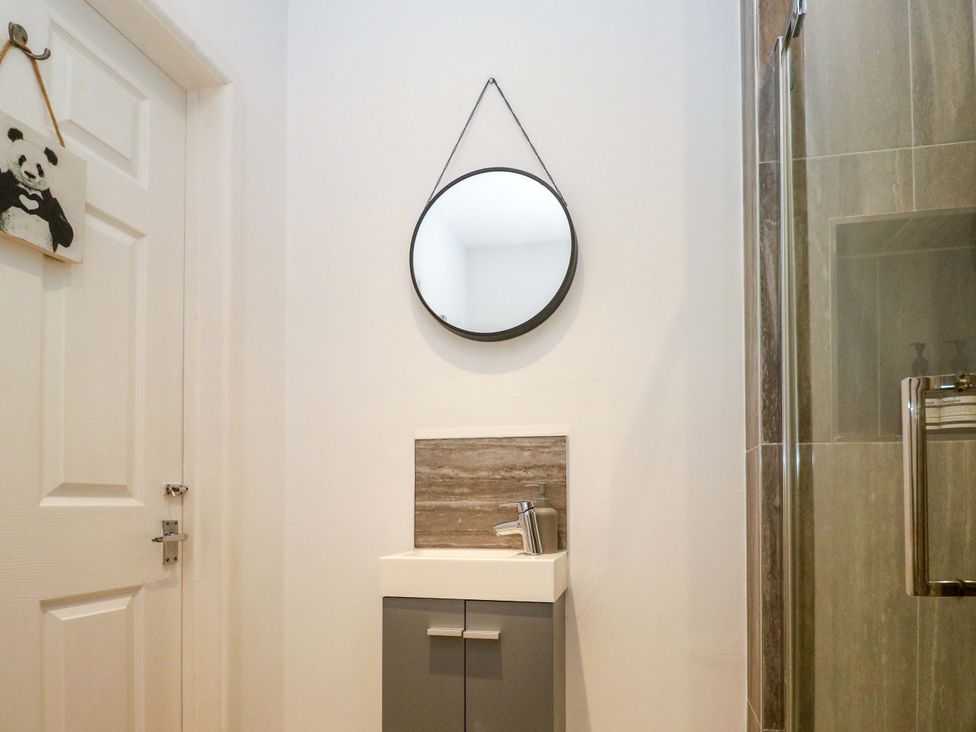 A bathroom with a sink and mirror at The Cow Shed in 
