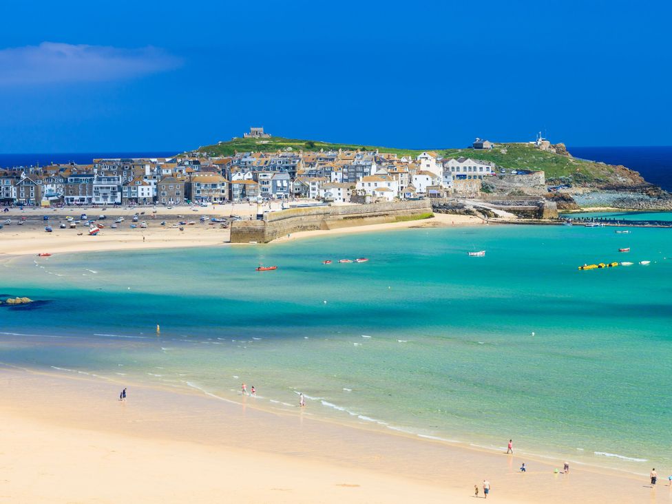 A coastal scene with buildings and beach at The Cow Shed in 
