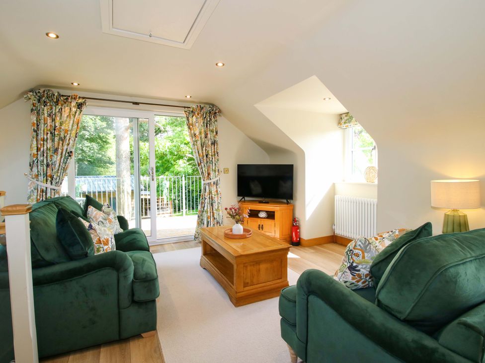 A living room with a sofa and coffee table at The Hideaway in Longden