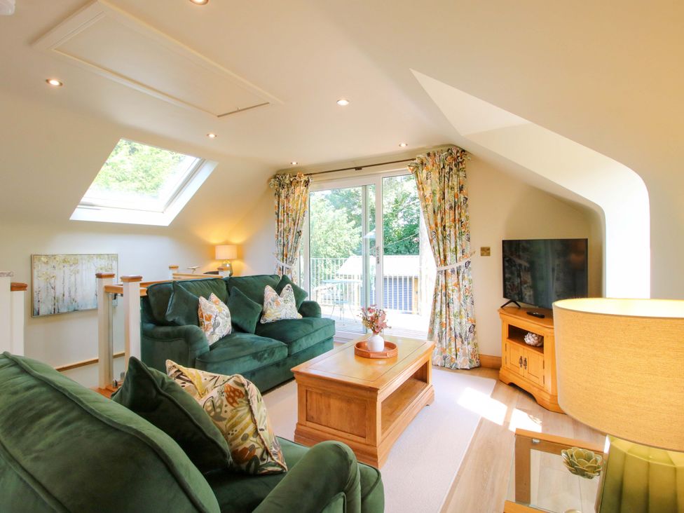 A living room with a sofa and coffee table at The Hideaway in Longden