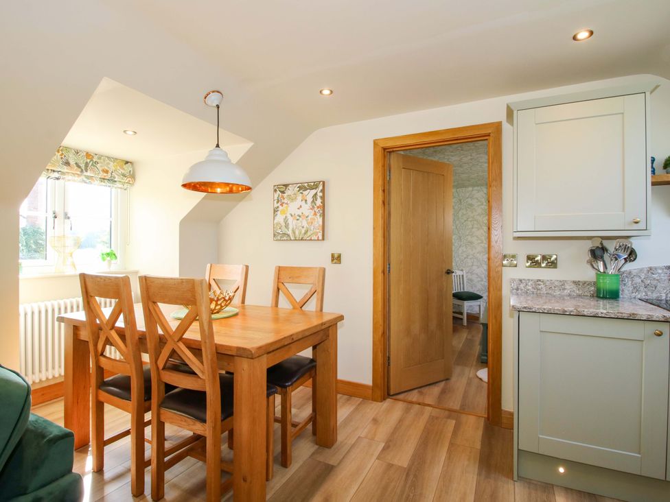 A dining room with a table and chairs at The Hideaway in Longden