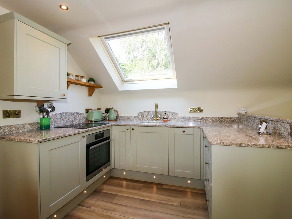 A kitchen with a countertop and window at The Hideaway in Longden