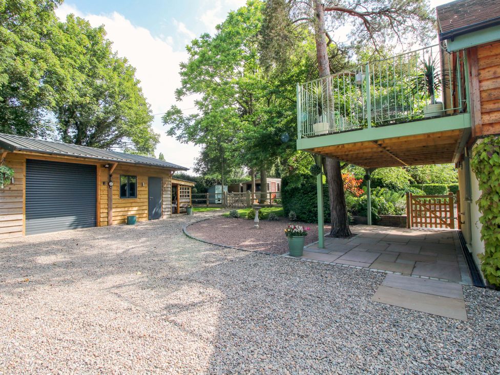 An outdoor area with a garage and a balcony at The Hideaway in Longden