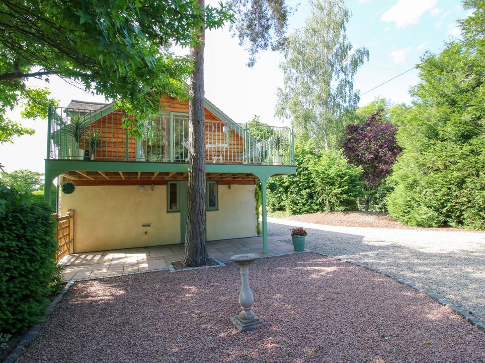 A house with a balcony and garden at The Hideaway in Longden