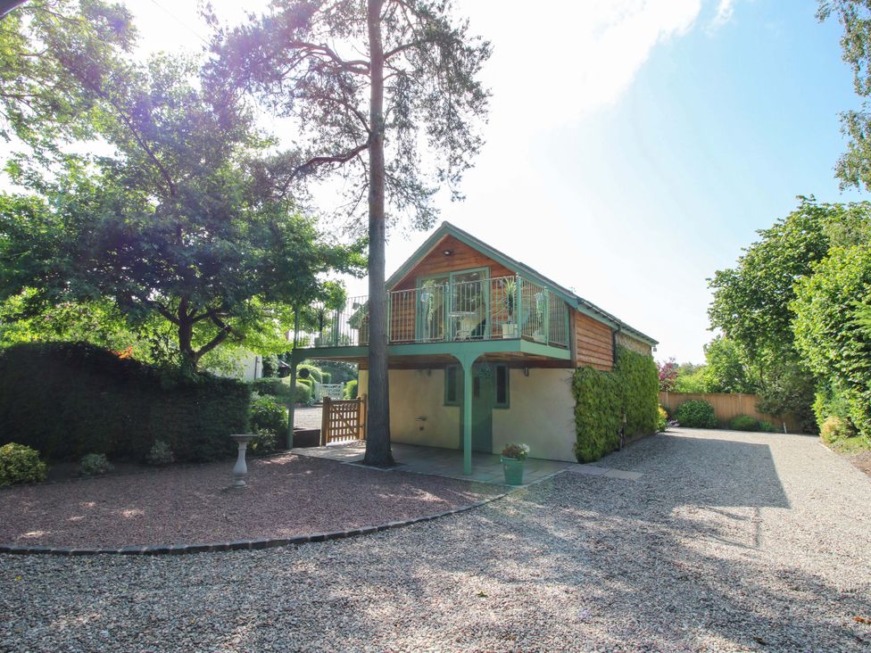 An outdoor view of a building with a balcony at The Hideaway Longden
