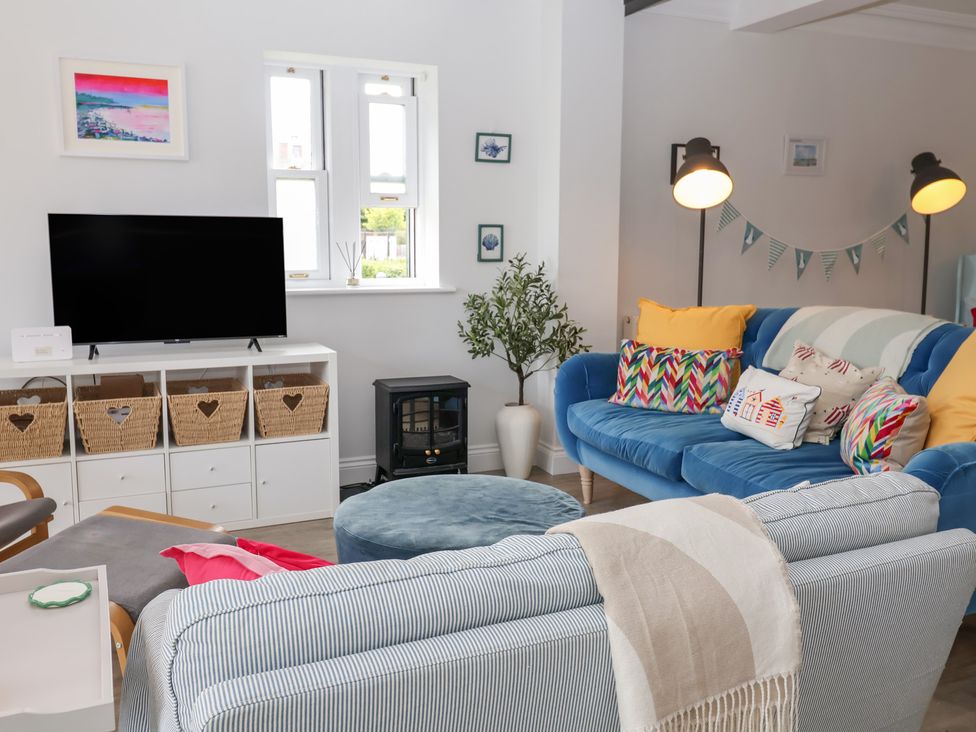 A living room with a television, sofa, and coffee table at Old Felixstowe, Bath Road, Felixstowe, Suffolk