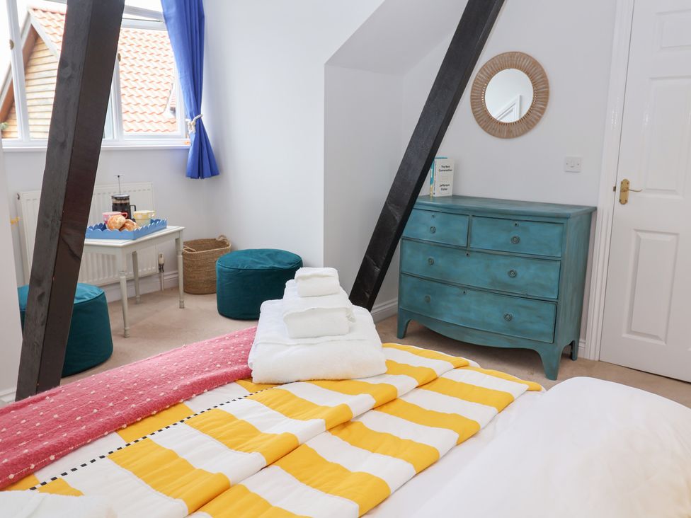 A bedroom with a bed and dresser at Old Felixstowe, Bath Road, Felixstowe, Suffolk