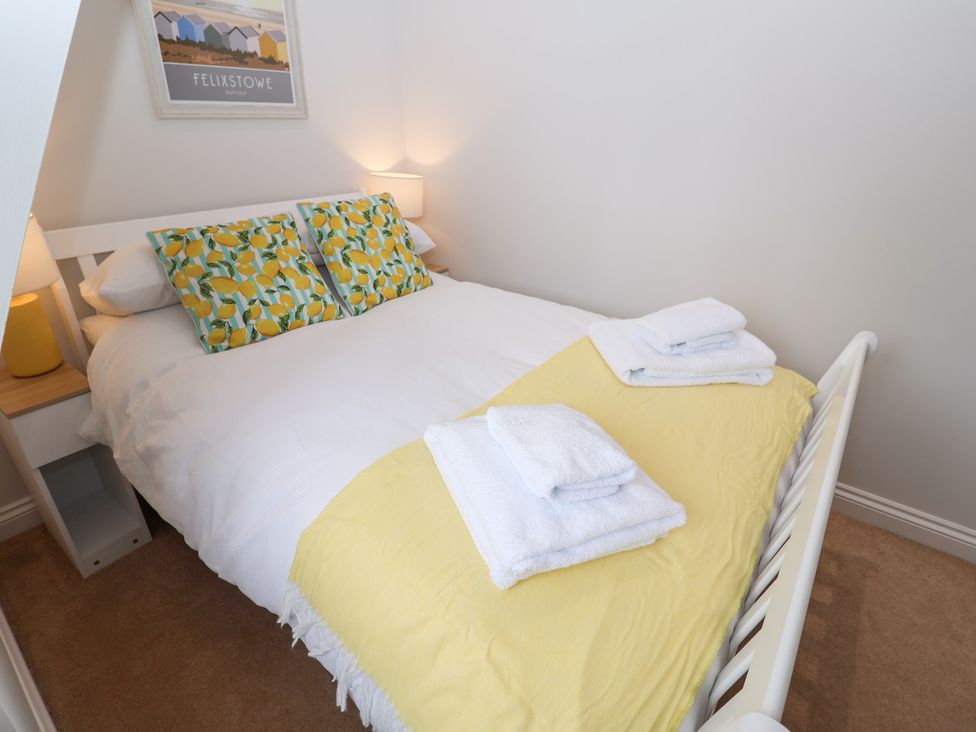 A bedroom with a bed and decorative pillows at Old Felixstowe, Bath Road, Felixstowe, Suffolk