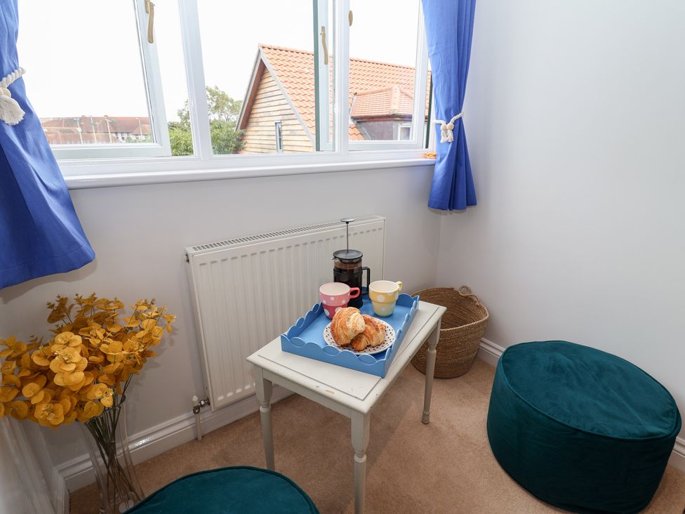 A snug with a table, cups, and a croissant at Old Felixstowe, Bath Road in Felixstowe, Suffolk
