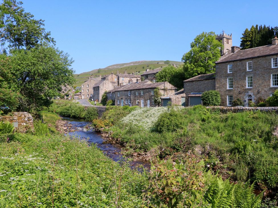 A view of stone houses and a river with trees at The Old Dairy in Richmond