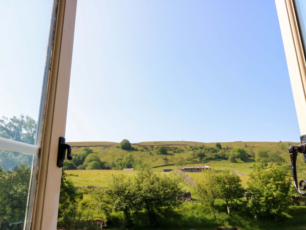 A view from a window showing hills and trees at The Old Dairy in Richmond
