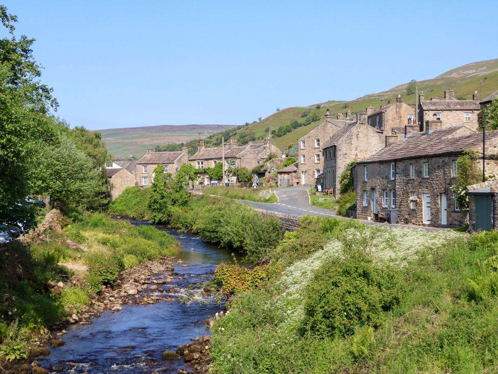 A village with houses alongside a river and a road at The Old Dairy in Richmond