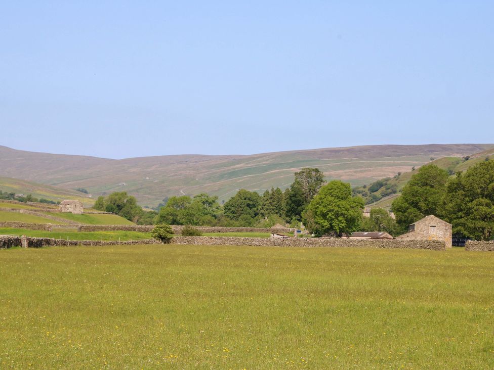 An open field with trees and stone buildings at The Old Dairy in Richmond