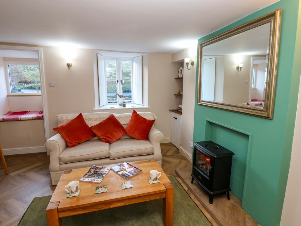 A living room with sofa and coffee table at The Old Dairy in Muker