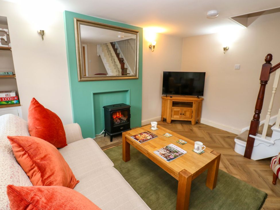 A living room with a sofa and coffee table at The Old Dairy in Muker