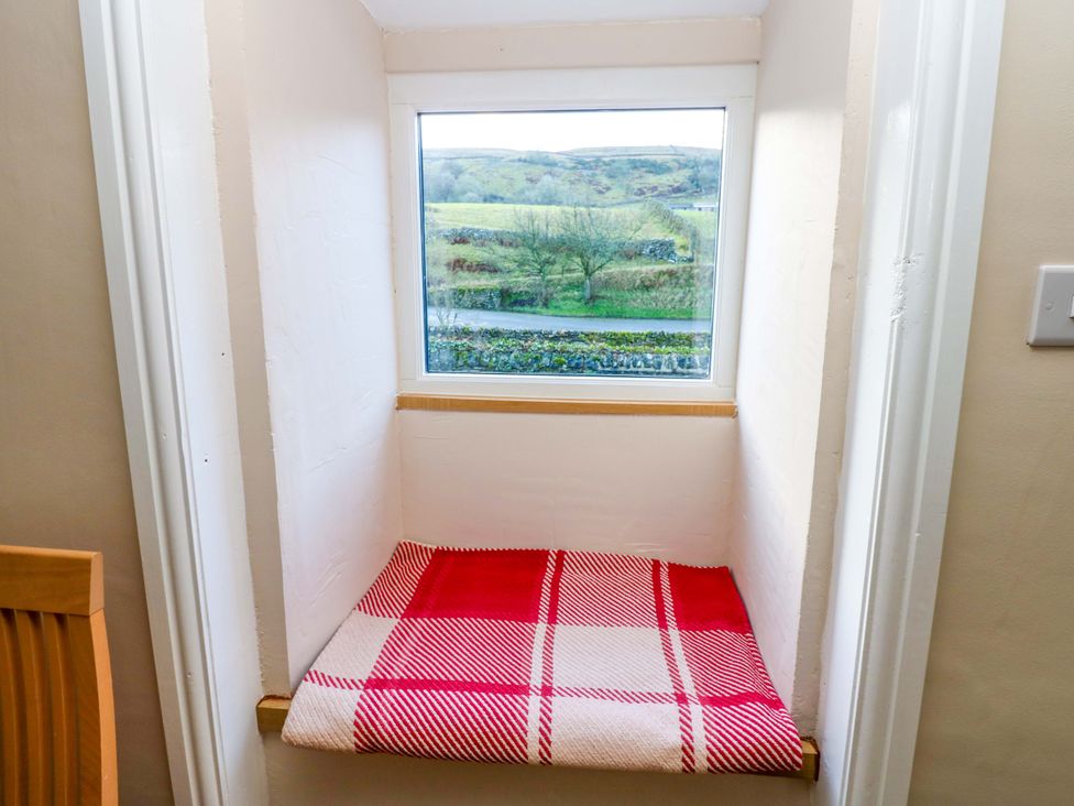 A nook with a window and a cushion at The Old Dairy in Muker