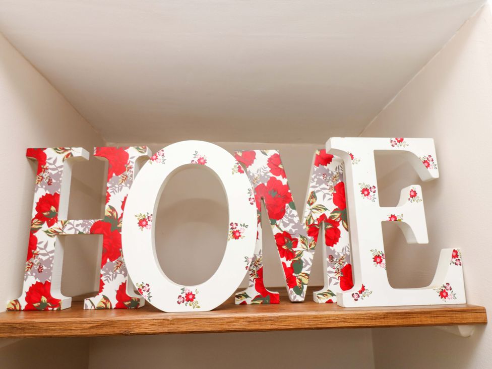 Decorative letters spelling home on a shelf at The Old Dairy in Muker