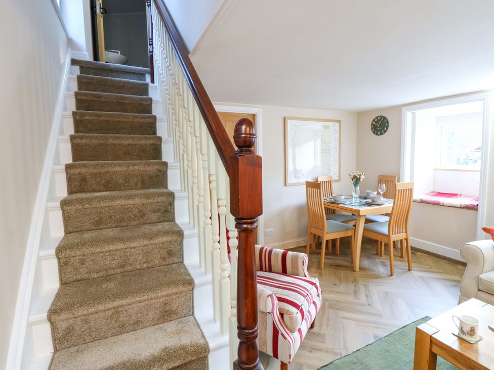 A dining area with a table and chairs at The Old Dairy in Muker